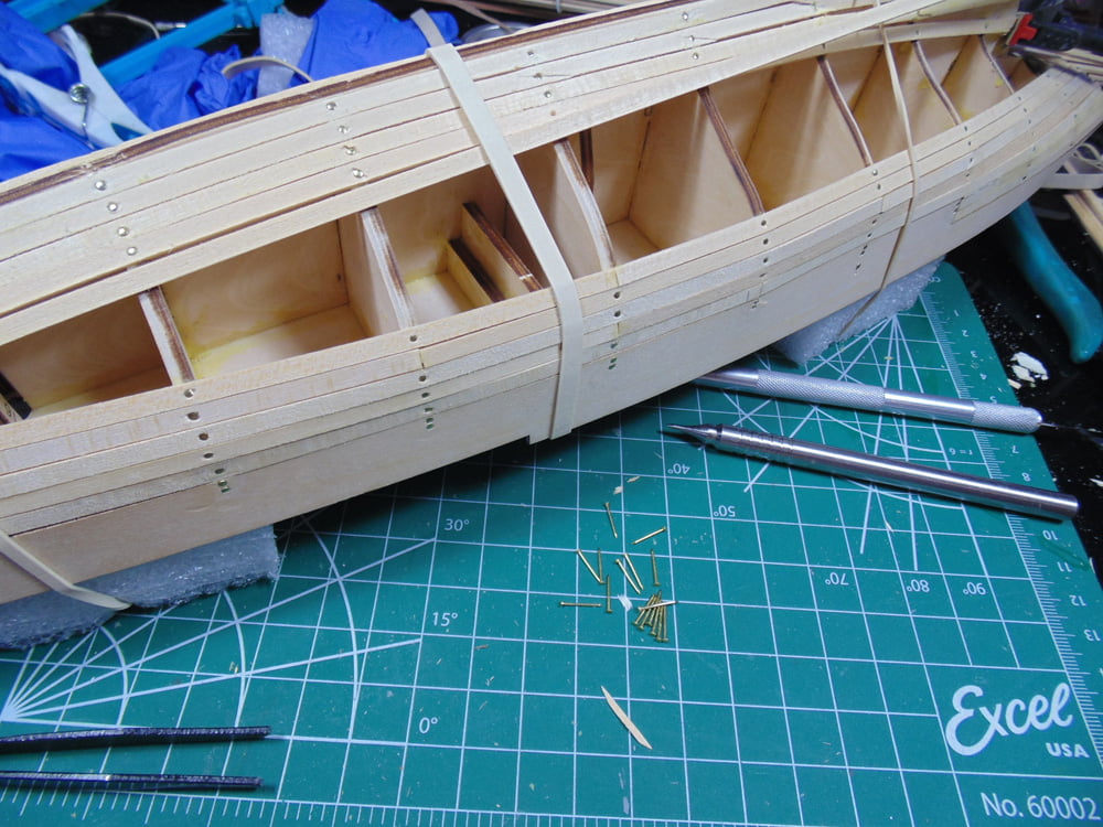 Unfinished hull with a dozen brass nails in front