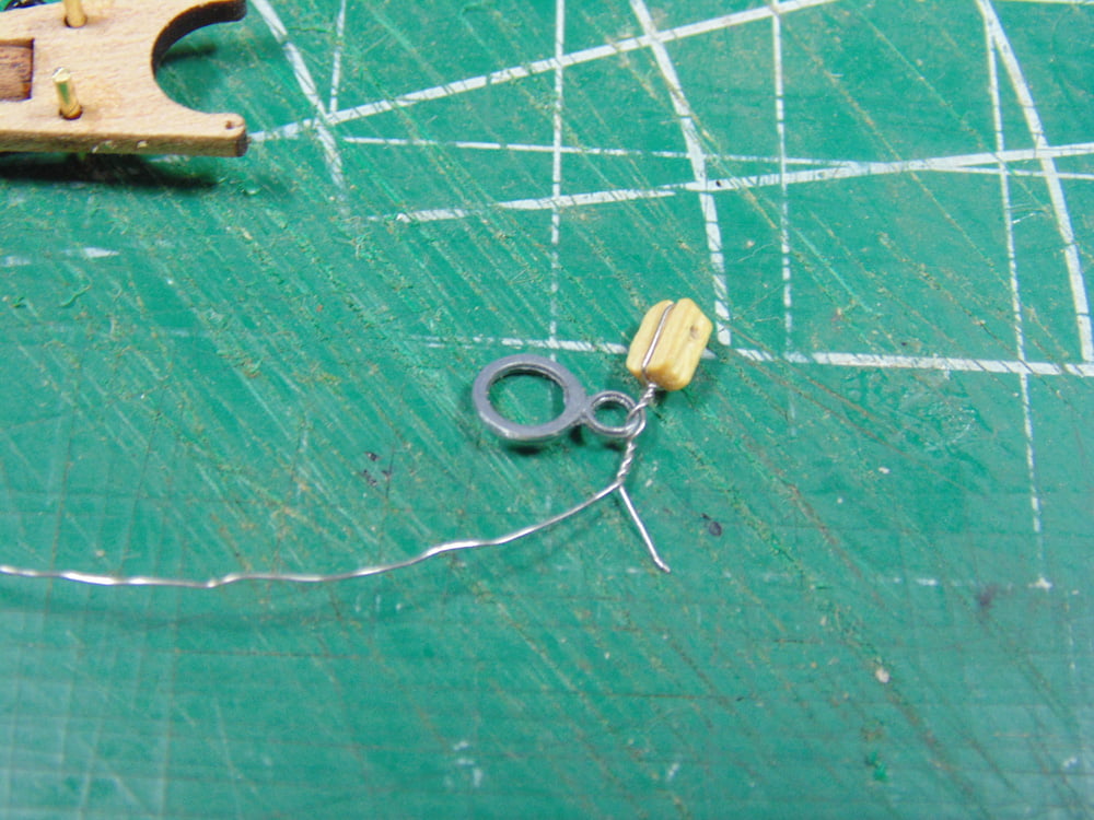 Block with twisted wire loop in tiedown