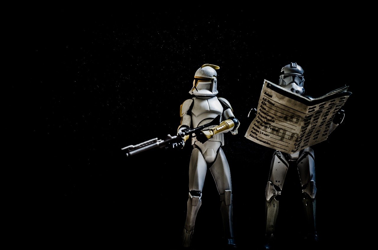 Angled offset Key light with black backdrop highlighting posed Starwar Figures